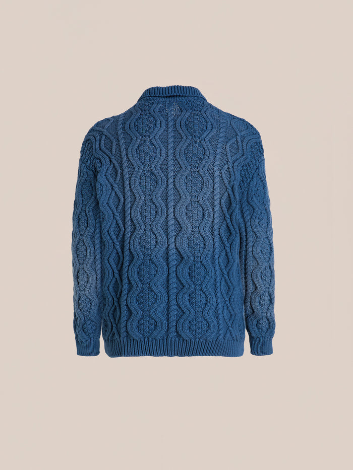 Found Cable Knit Buttoned Cardigan shown from the back against a plain beige background.