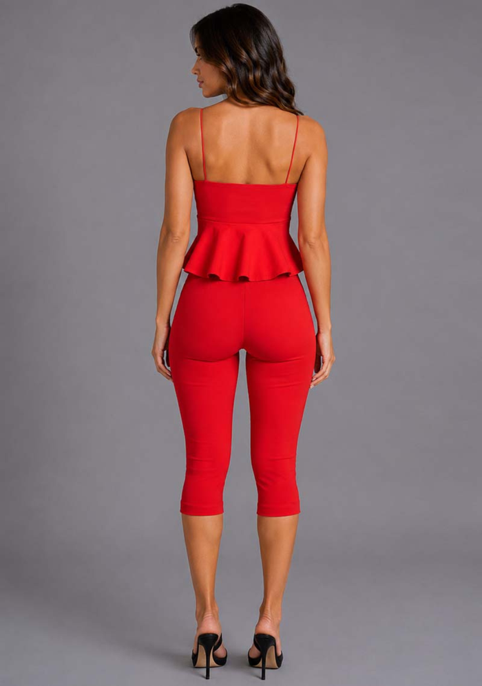 Back image of a model wearing the VSPR Capri Cropped Red Pants featuring a sleek body-contouring fit, contemporary cropped hem, and polished finish, standing against a grey studio backdrop.