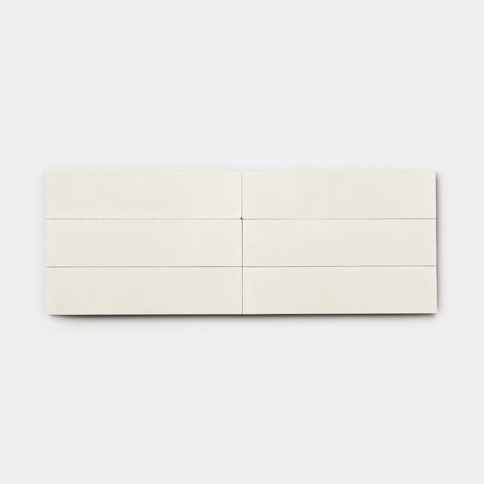 The Cotton 2x8 by vendor-unknown is a minimalist white rectangular tile, divided into six equal sections with thin lines, displayed on a light gray background—ideal for a modern kitchen backsplash.
