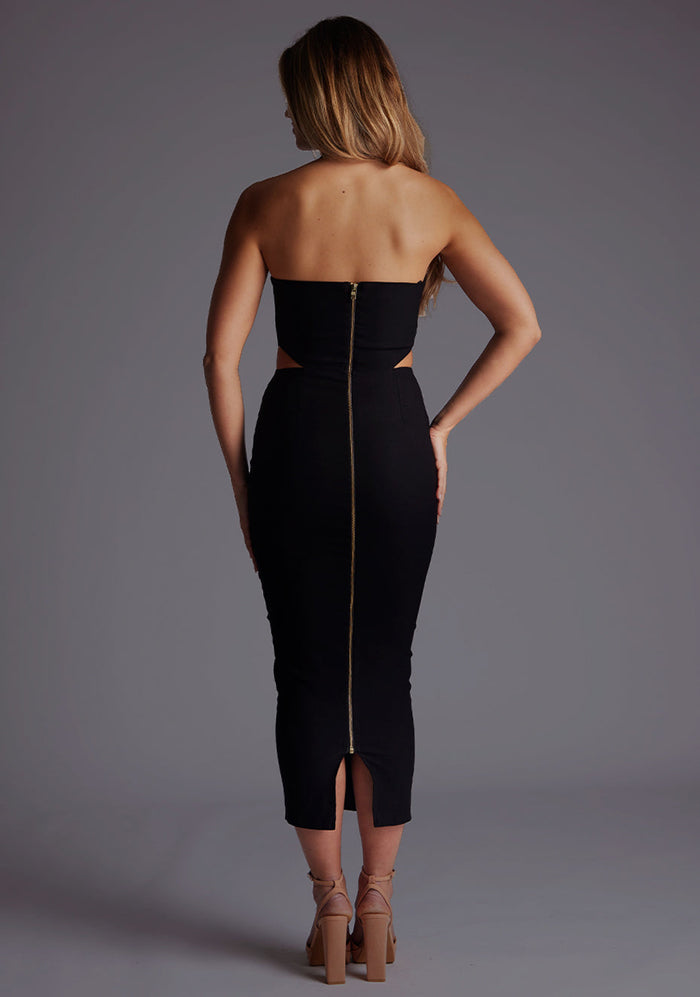 Back image of a model wearing the Vesper Dalton Cross Neckline Midaxi Dress in Black featuring a clean, minimalist back and elegant midaxi length.