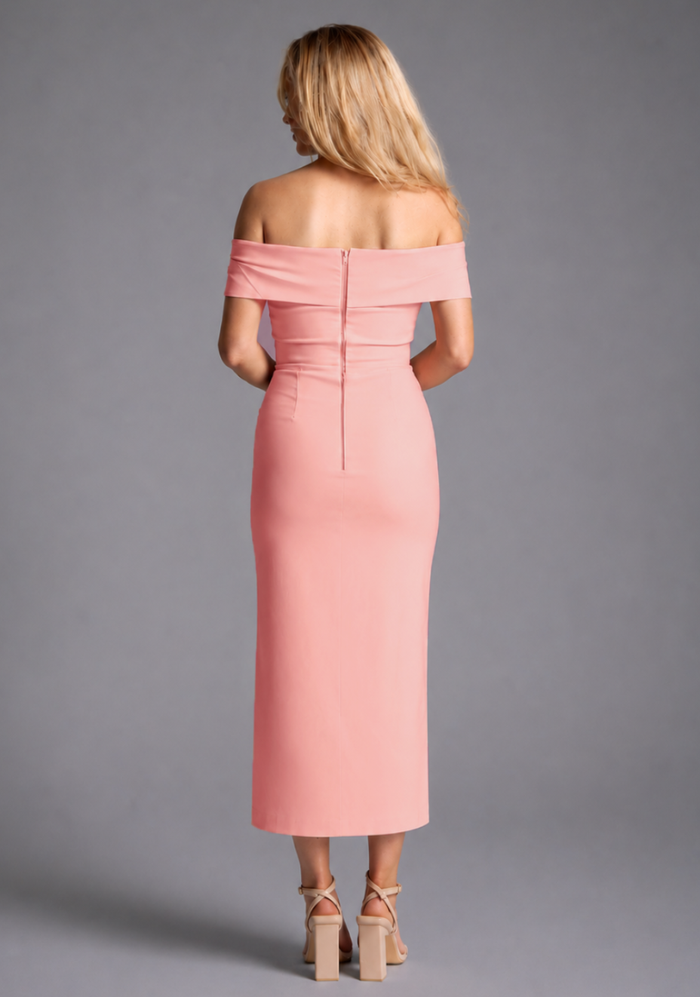 Vesper peach bardot ruched midaxi dress with off shoulder neckline and front split, back view on blonde model against grey studio background.
