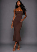 Front image of a model wearing the VSPR Marianna Chocolate Brown Midaxi Dress featuring a structured square neckline, wide straps and a figure-contouring fishtail silhouette against a grey studio backdrop.