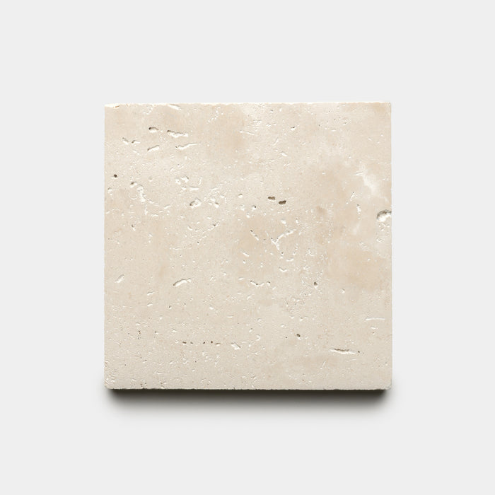 The Mesa 6x6 by Zia Tile is a single square beige tile featuring a textured surface with small natural holes, shown against a plain light gray background.