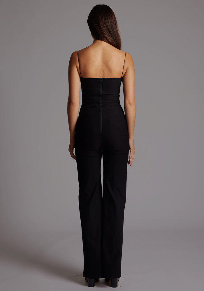 Back image of a model wearing the VSPR Rogan Sweetheart Neck Wide Leg Jumpsuit in Black, featuring a discreet back zip and a sleek, uninterrupted silhouette.