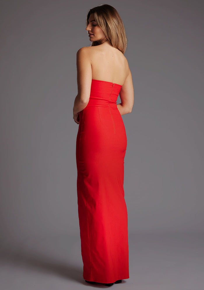 Side view of the Thyme strapless red maxi dress showcasing the sleek fitted silhouette, strapless neckline and graceful maxi length.