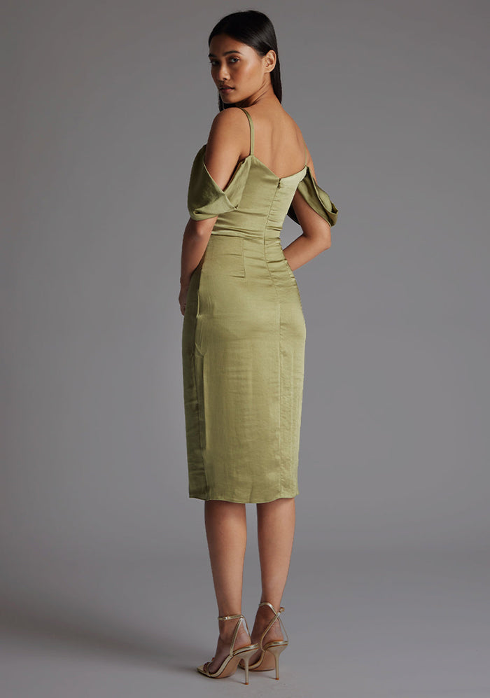 Back quarter image of model wearing a olive satin bardot midi dress with a  delicate allure satin, cowl neckline and invisible back zip with thin straps and draped arm bands.  The design featured is the Vesper Victoria Olive Satin Bardot Midi Dress